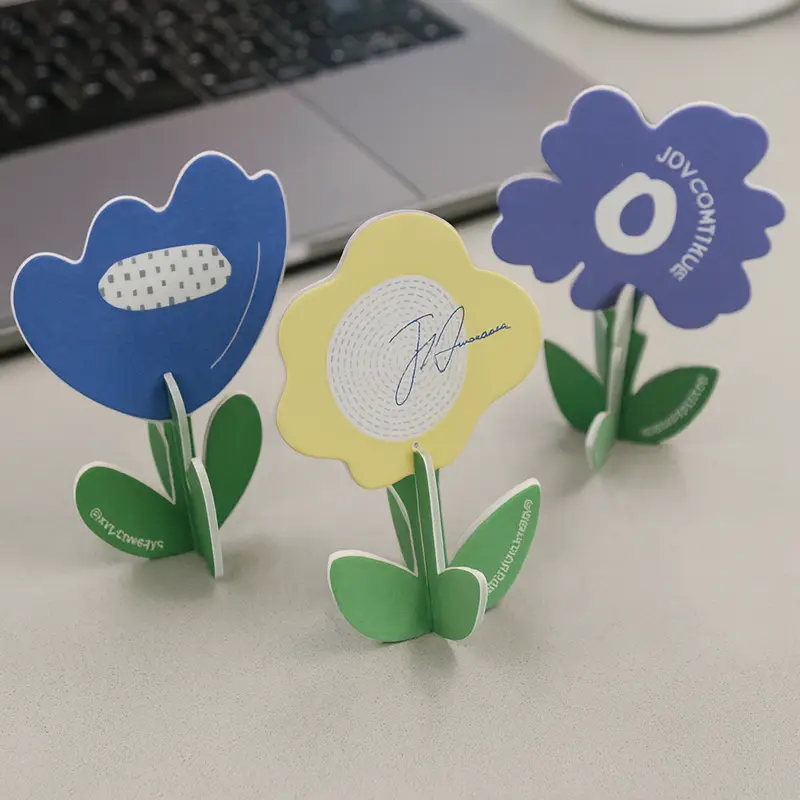 Several flower-shaped, proprietary brand paper air fresheners are placed on the table