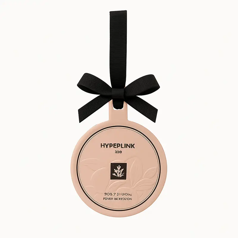 Round paper air freshener with embossed design and hanging ribbon in mint scent