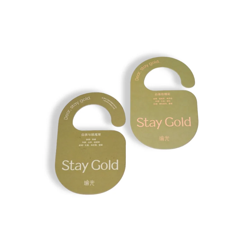 Stay Gold white tea & sage hotel door air freshener hanging on table background