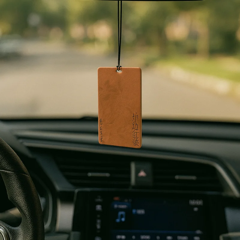 Red tea car air freshener hanging from rearview mirror – natural tea-inspired scent inside vehicle